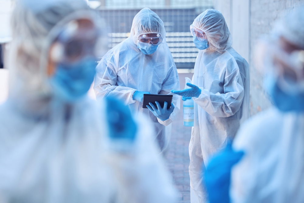 Cleaning, tablet or team of scientists in hazmat or mask virus for sanitation research in outbreak crisis. Technology, teamwork and people outside for healthcare report, covid or pandemic disease