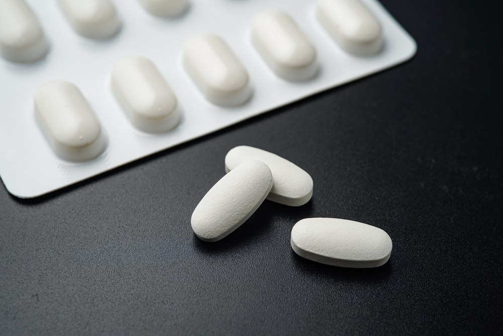 Antibiotic pills Medicine tablet capsules in blister pack on a black background