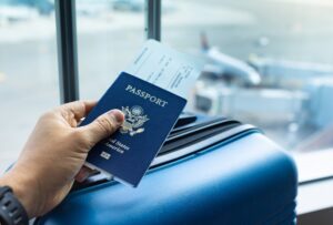 hand holding US passport at airport