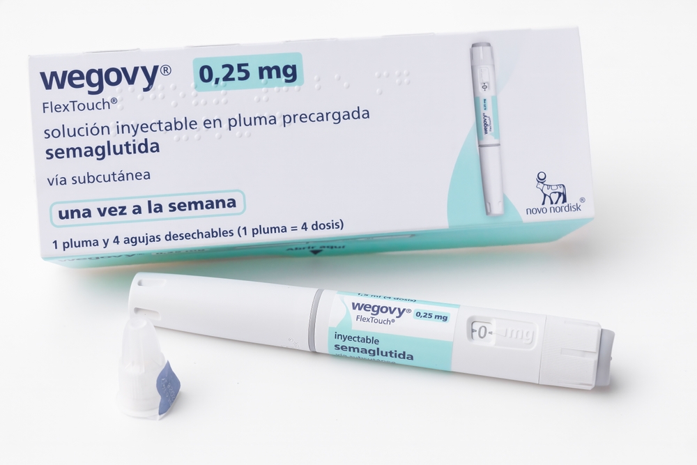 Barcelona, Spain - October 8, 2024: Packaging box and pen of Wegovy, semaglutide injectable for weight loss. Translation: Solution for injection in pre-filled pen. Subcutaneous use. Once a week.