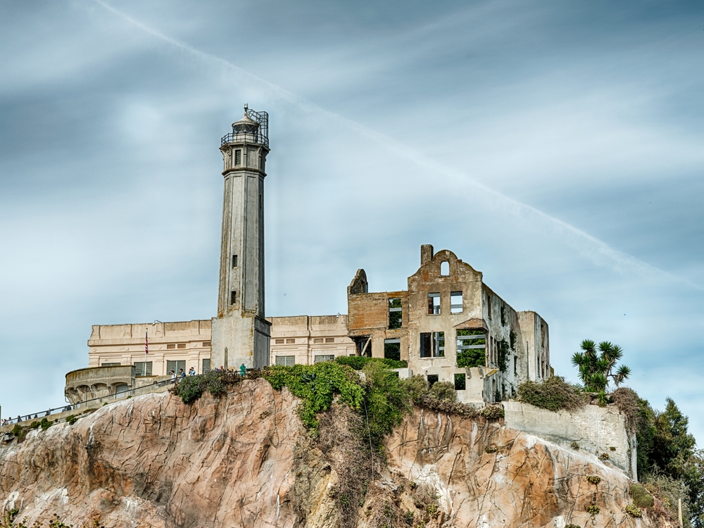 ALCATRAZ, CALIFORNIA - OCTOBER 28, 2022: A tall guard tower stands watch over the penitentiary on the hill at the Alcatraz Federal Penitentiary.