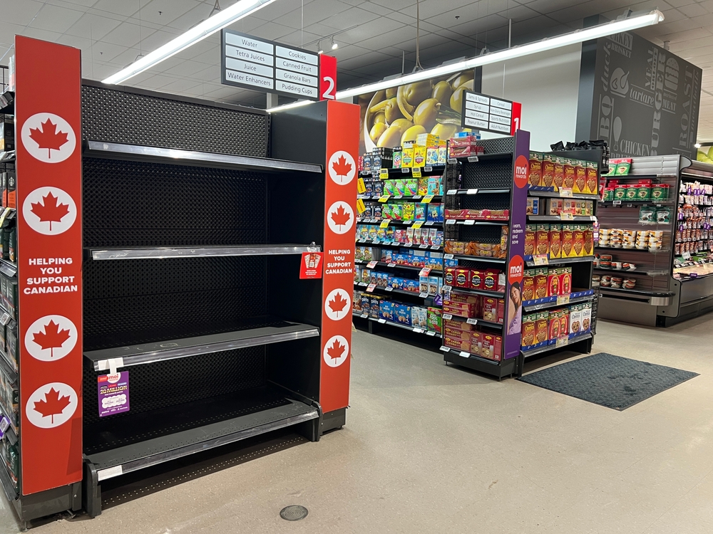 St. Catharines, Ontario, Canada - March 12, 2025 : Empty display shelves featuring Canadian made product branding are completely sold out In comparison to adjacent U.S products.