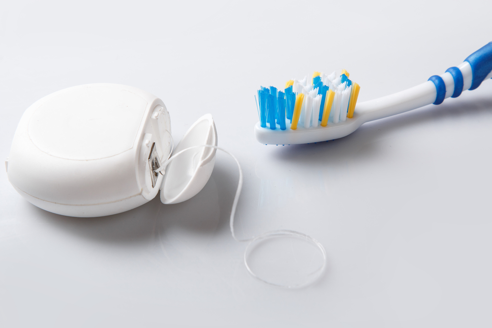 Close up of toothbrush and dental floss