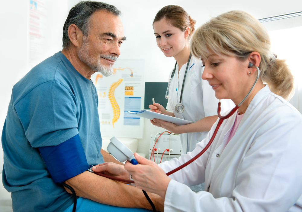 Patient is being observed by doctor - measuring blood pressure