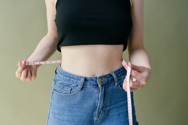 woman measuring her waist