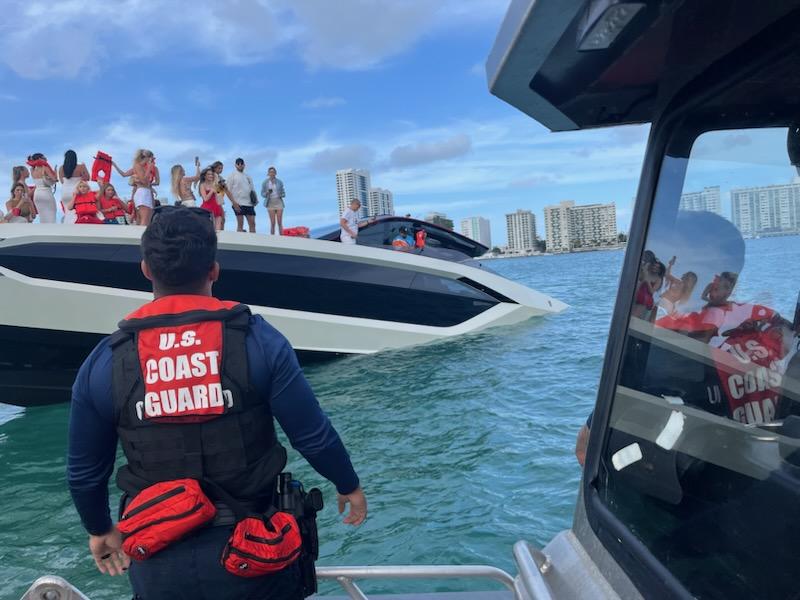 US Coast Guard with luxury yacht on water