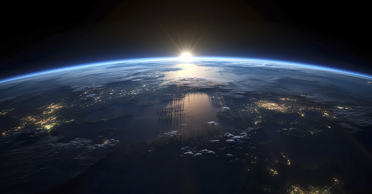 Sun rising over earth's horizon, seen from orbit