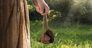 Three-Year-Old Discovers Millennia-Old Amulet Where David Defeated Goliath hand holding a sling, a weapon used to throw projectiles. The sling was famously used by David to defeat Goliath in the biblical story.