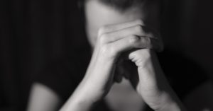 Suicide Pod Co-President Dies by Suicide After First User’s Death and Police Detention person with their hands clasped together, possibly in prayer or contemplation