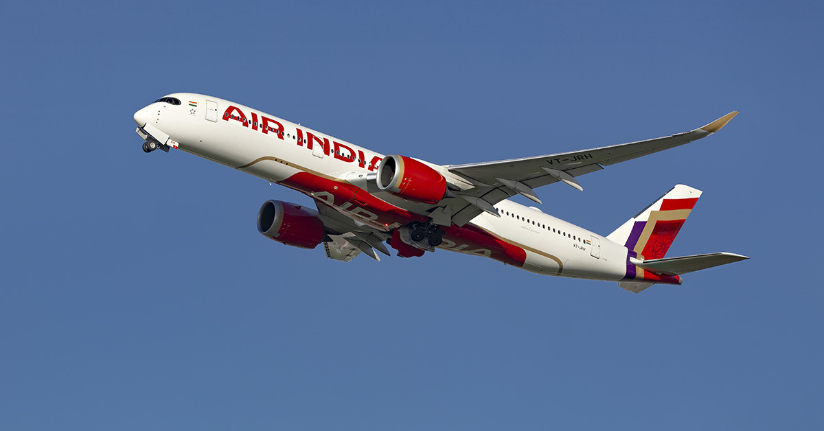 Air India jet flying with a blue sky in background