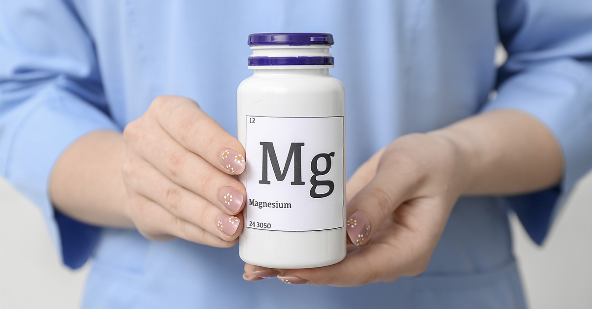 woman holding a Magnesium supplement bottle