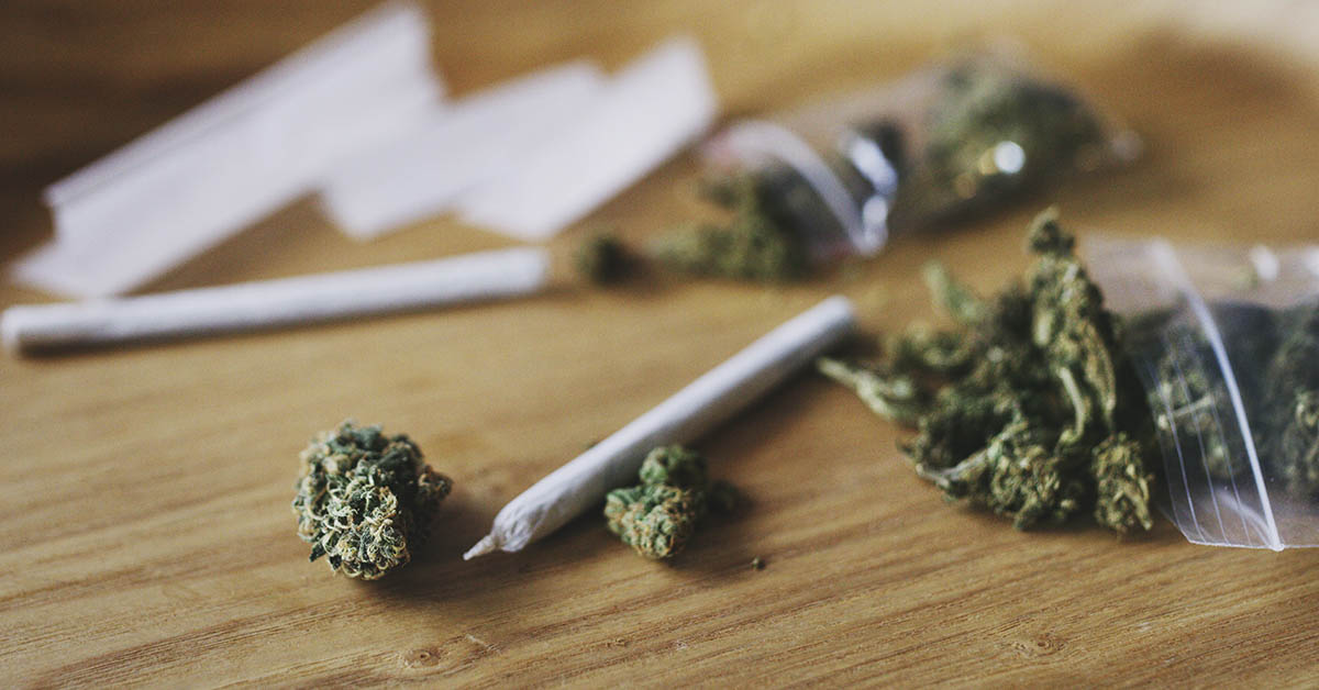 Marijuana joint and bud on table