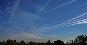 Florida Enacts Law Banning 'Chemtrails' and Weather Modification Practices Contrails seen in sky as sun sets. Chemtrail conspiracy concept