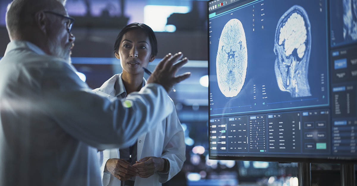 doctors examining brain scans on screen