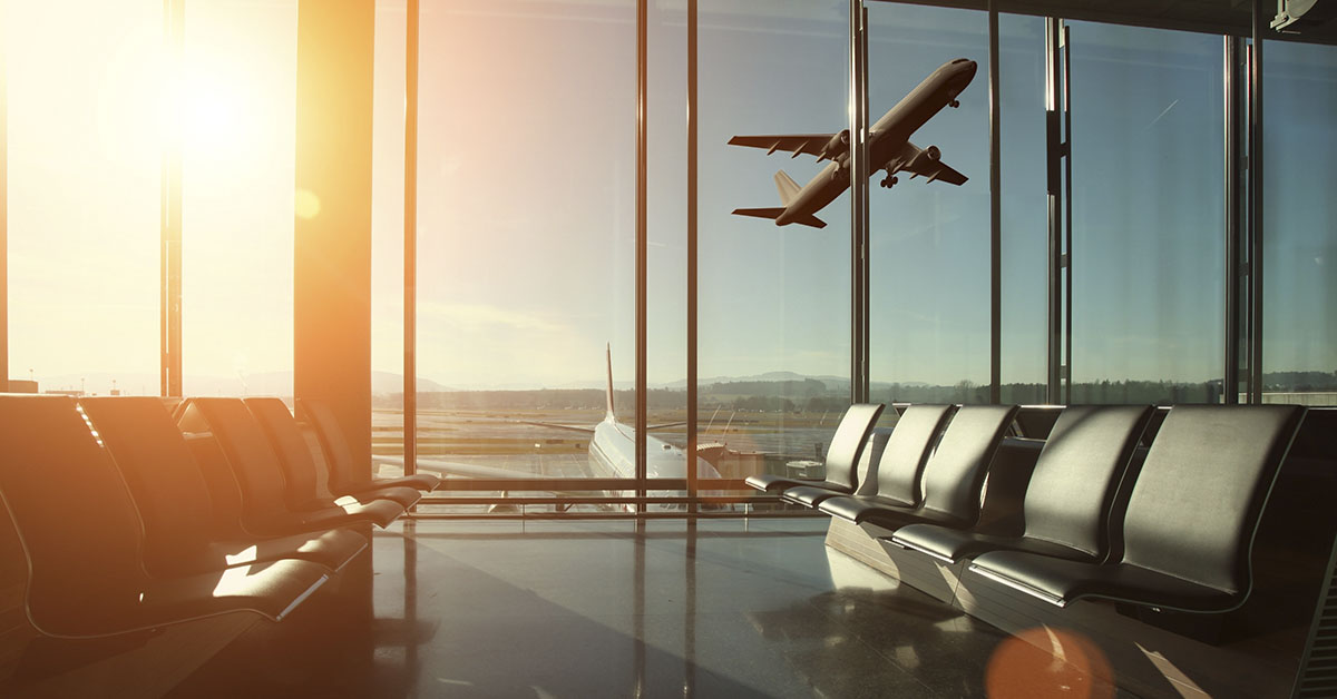 commercial jet flying buy office window.