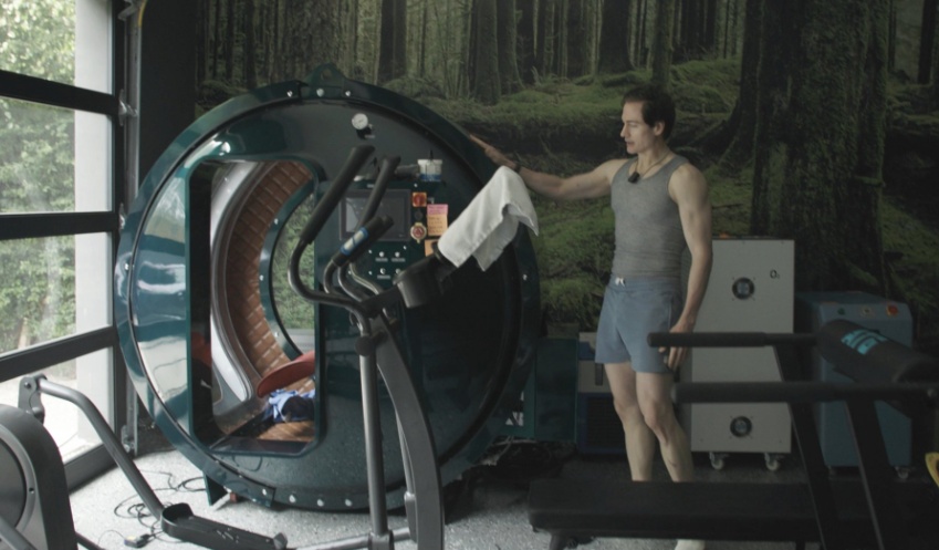 Bryan Johnson beside hyperbaric chamber