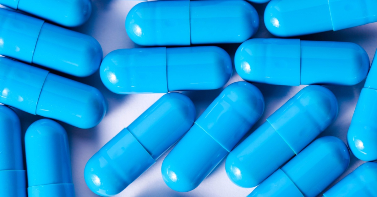 Blue capsules on white background.