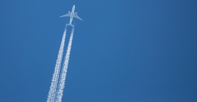 plane and contrails in the sky