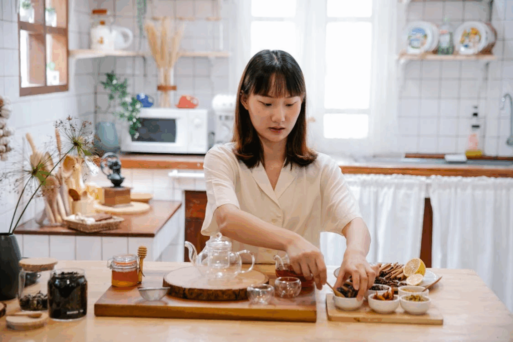 A woman creates her morning elixir in a sun-filled kitchen, turning simple ingredients into health and wellness gold.