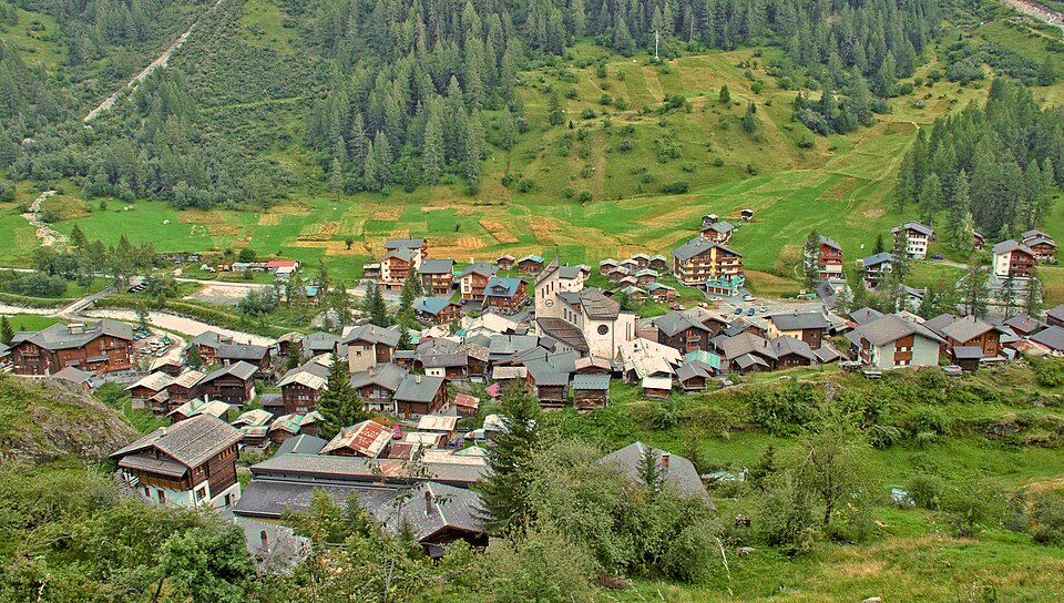 The Alpine village with traditional homes and red roofs spread across green meadows, where 300 residents lived for centuries.