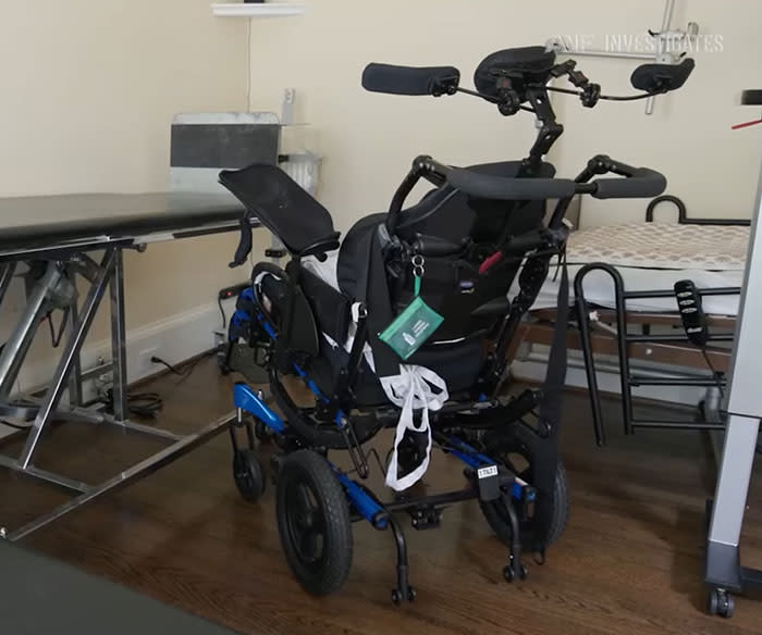 Specialized wheelchair with medical equipment and monitoring devices required for Jonathan's daily care.