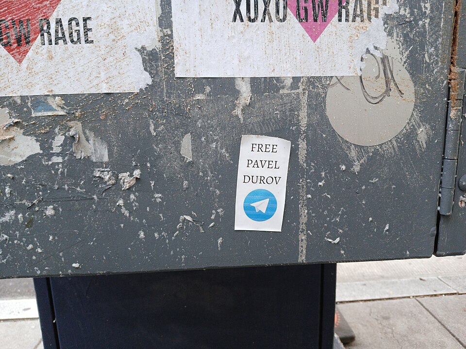 Street sticker reading 'FREE PAVEL DUROV' with Telegram logo.