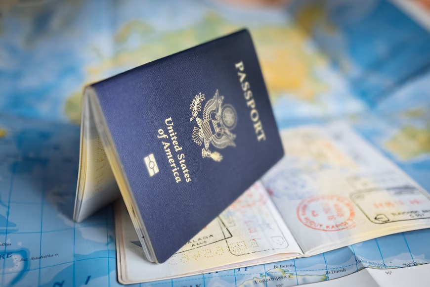 American passport on top of a map. Be sure to check worldwide travel warnings before travel