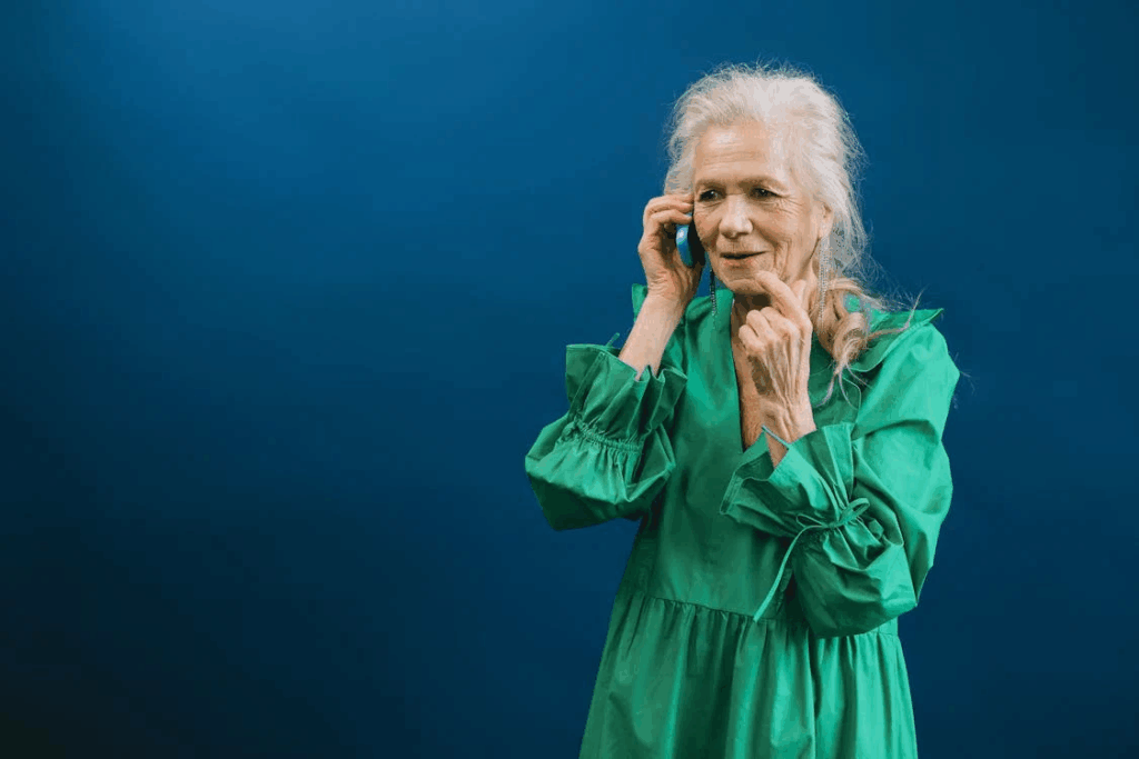 Elderly Woman in Green Dress Talking on the Phone