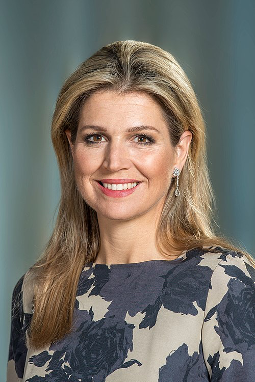 Queen Máxima of the Netherlands smiling in a floral outfit.
