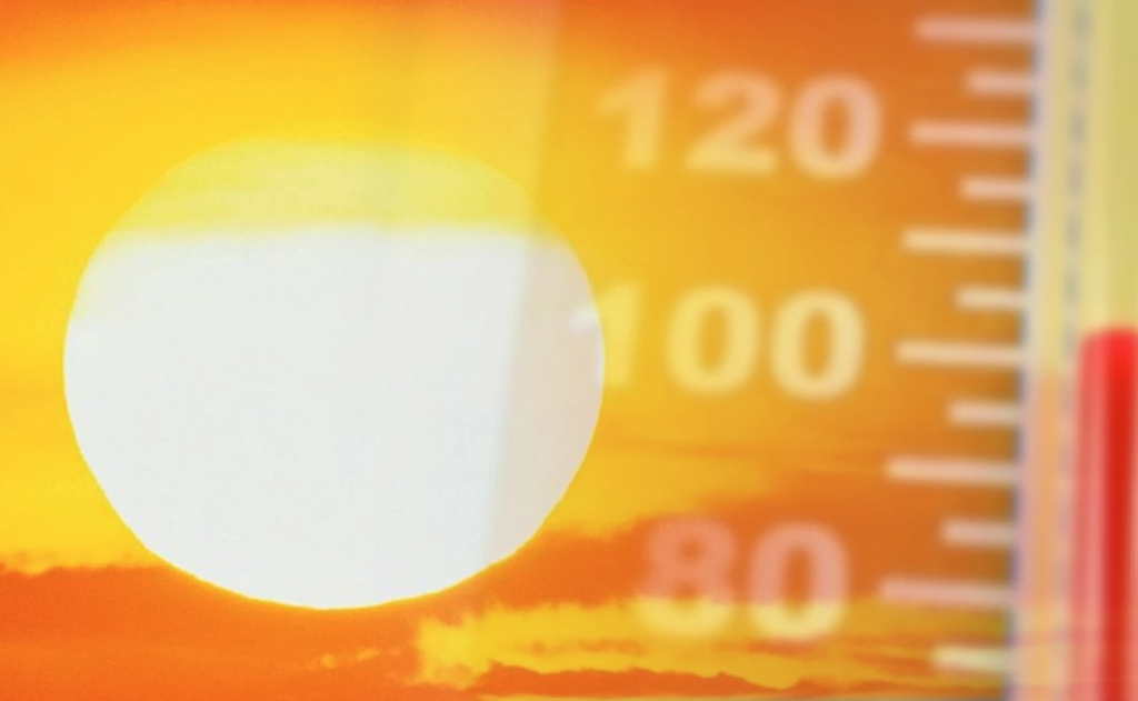 Close-up view of a thermometer displaying temperatures above 100°F during extreme heat conditions.