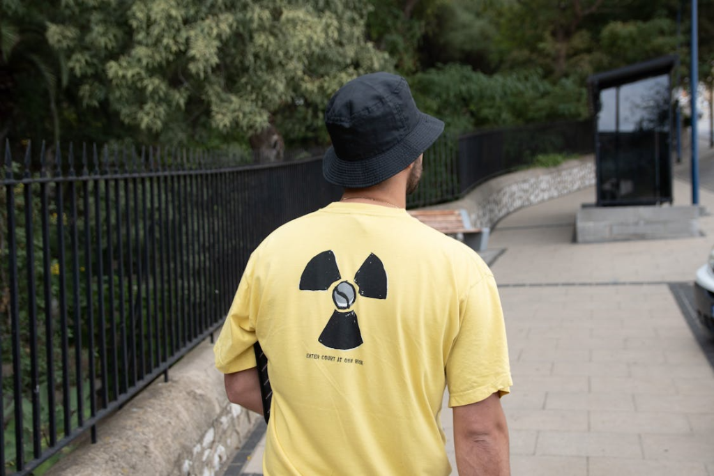 Back View of a Man Wearing Yellow Shirt and Black Bucket Hat