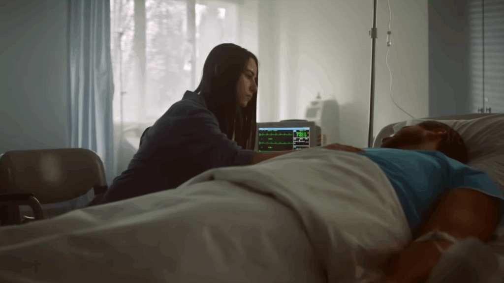 Patient receiving comfort care in hospital bed with monitoring equipment.