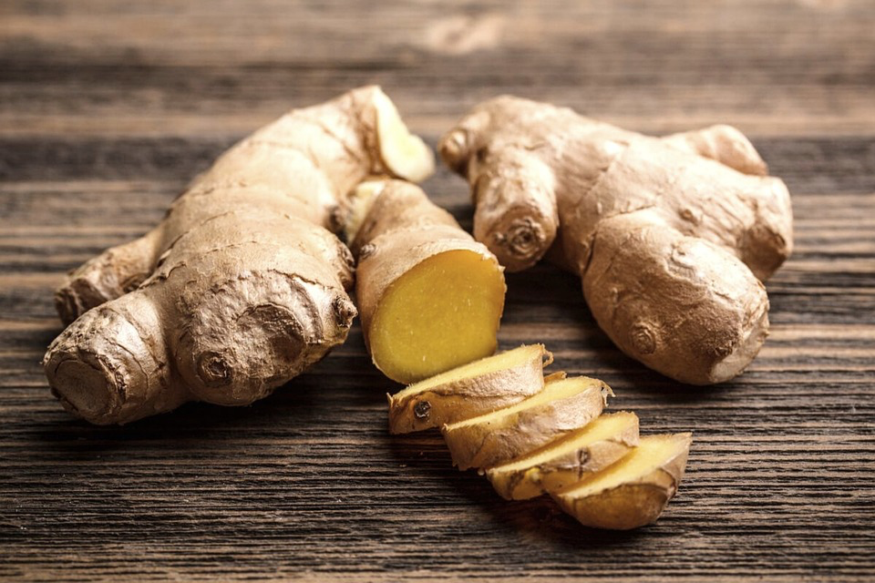 Fresh ginger root with its golden flesh exposed, your go-to ingredient for fighting nausea and inflammation.