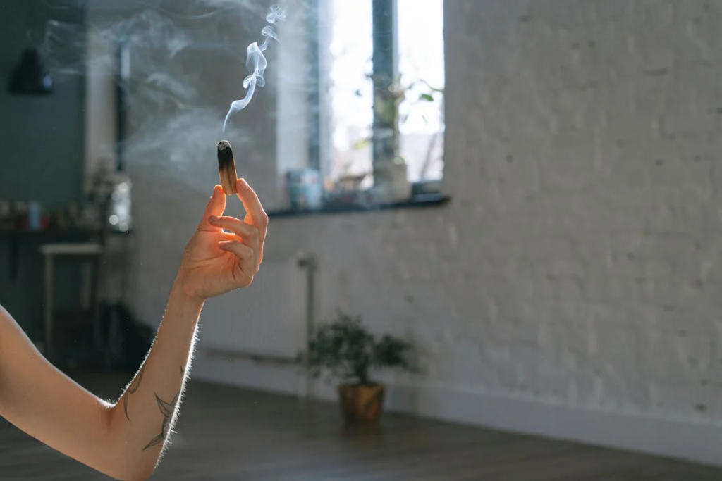 A Person Holding Burning Palo Santo