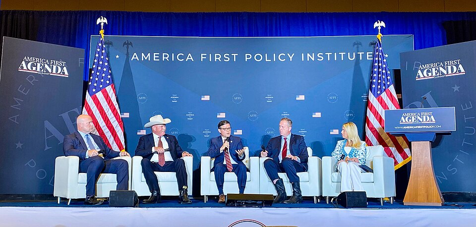 America First Policy Institute panel discussion with speakers seated on stage.