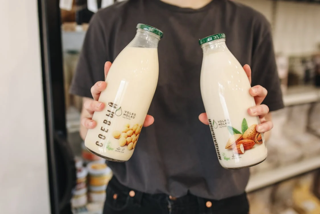 Person Holding Bottles with Milk