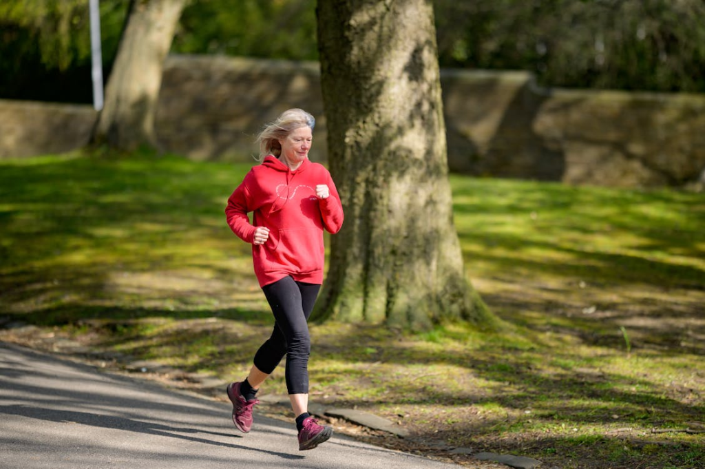 Girl in Red Hoodie and Black Leggings Jogging
