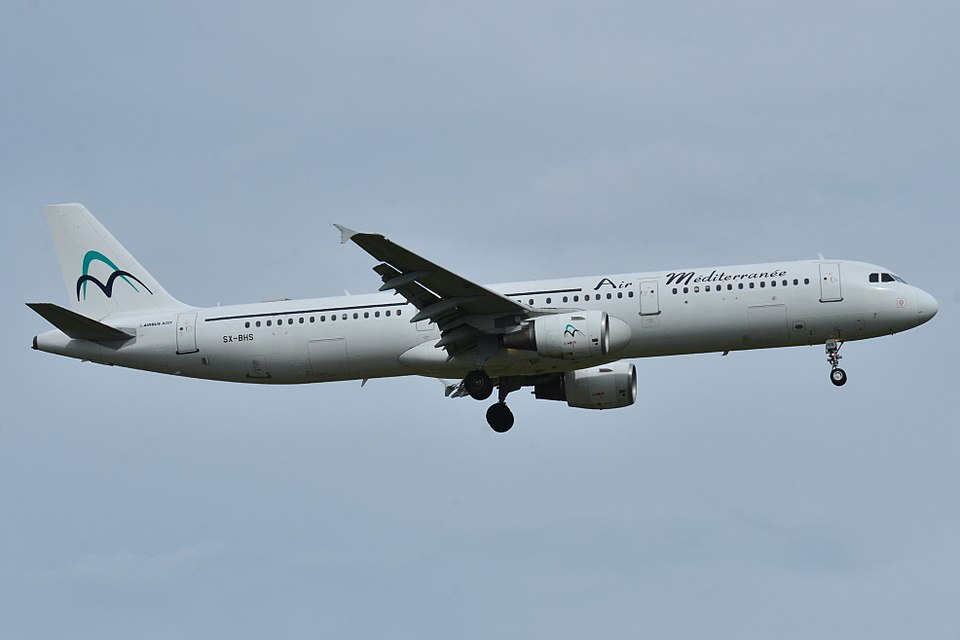 Daallo Airlines Airbus A321 aircraft in flight against cloudy sky.