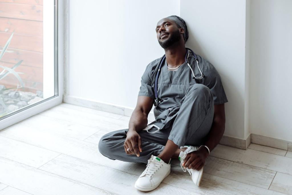 An Exhausted Medical Professional Sitting on the Floor