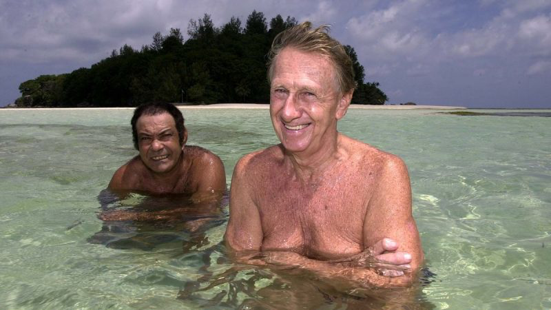 Brendon Grimshaw and René Antoine Lafortune enjoying shallow tropical waters near Moyenne Island, showing their simple island lifestyle.