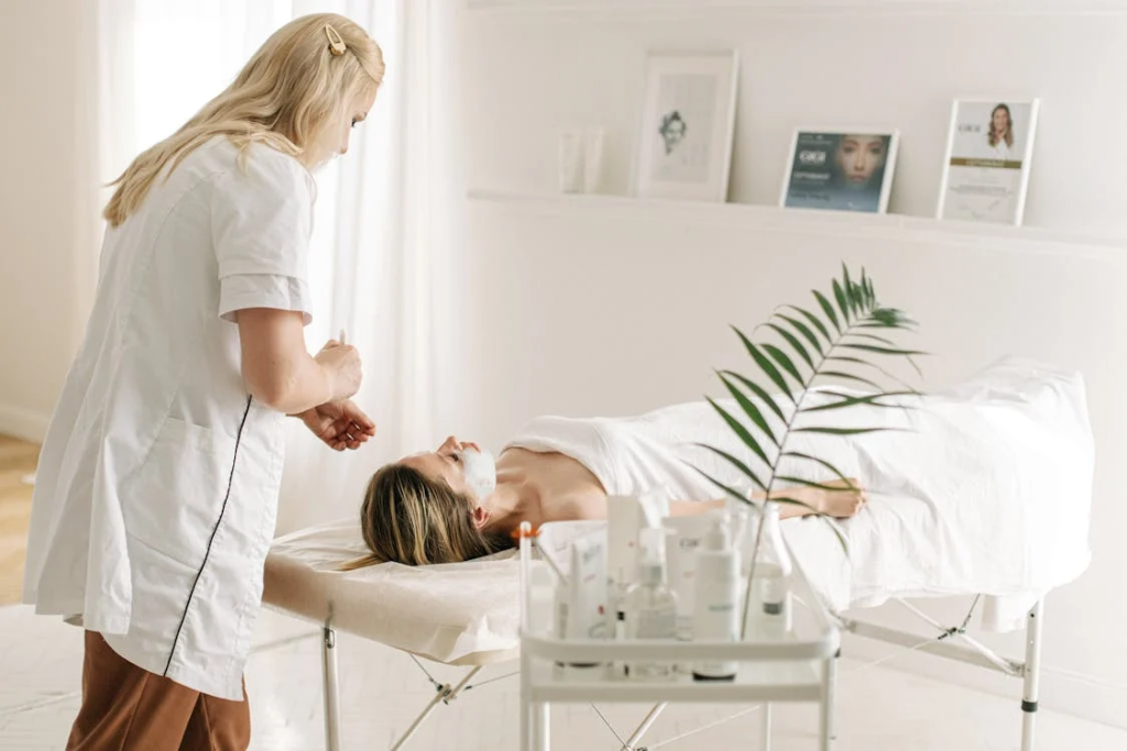 A Dermatologist Applying Facial Mask on Customer's Face
