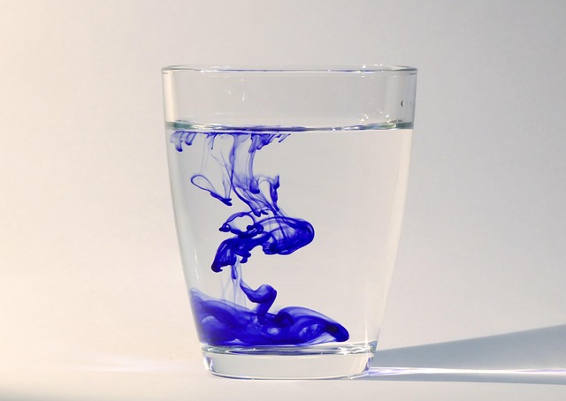 blue dye in a glass of water