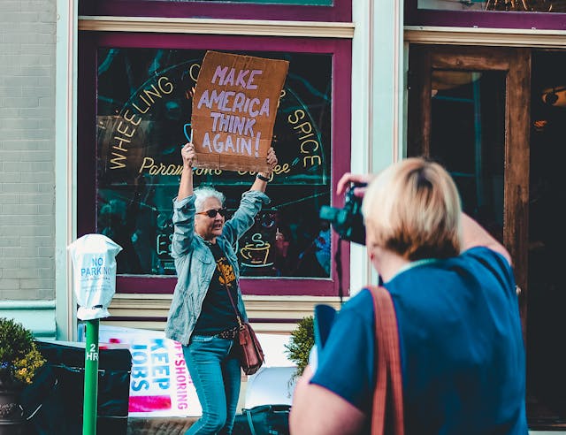woman holding sign at rally