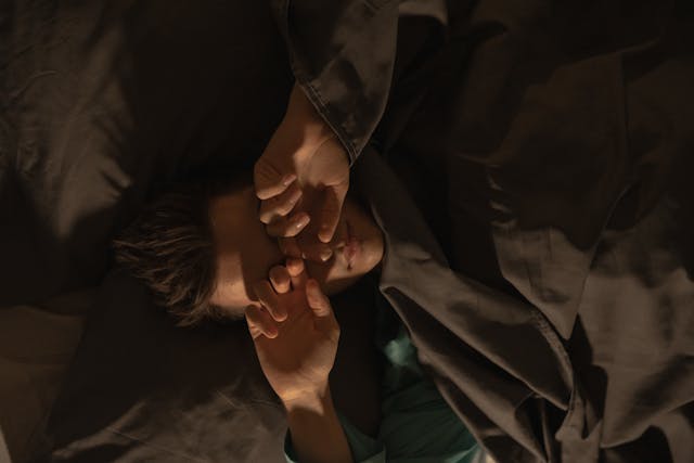 man sleeping in bed