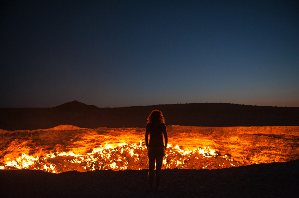 Darvaza, Turkmenistan - Staring into the flaming gas crater known as the Door to Hell In Darvaza, Turkmenistan.