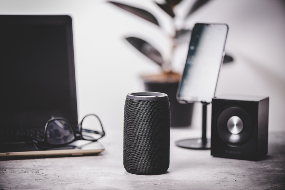 Black wireless portable bluetooth speaker for music listening. Voice assistant speaker at home.