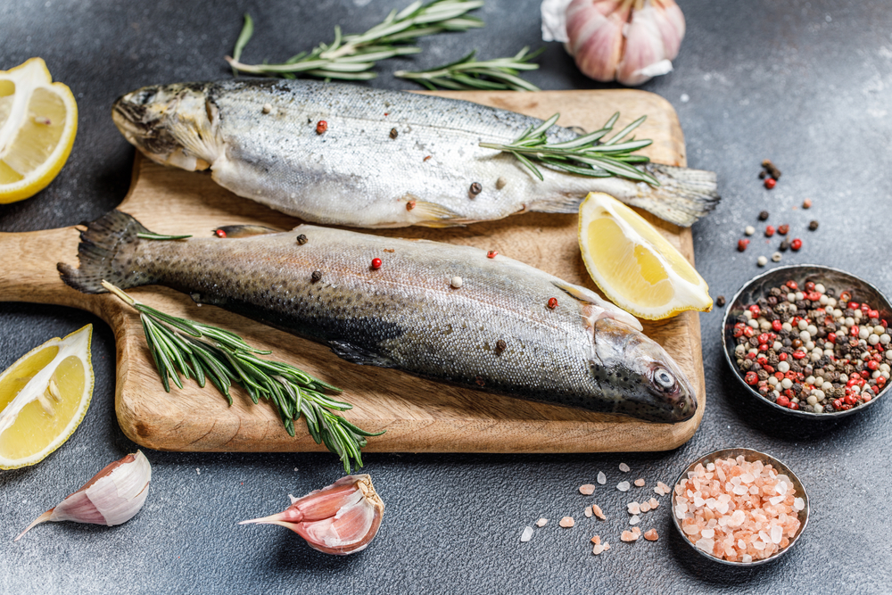 Fresh rainbow trout with spices and ingredient for cooking