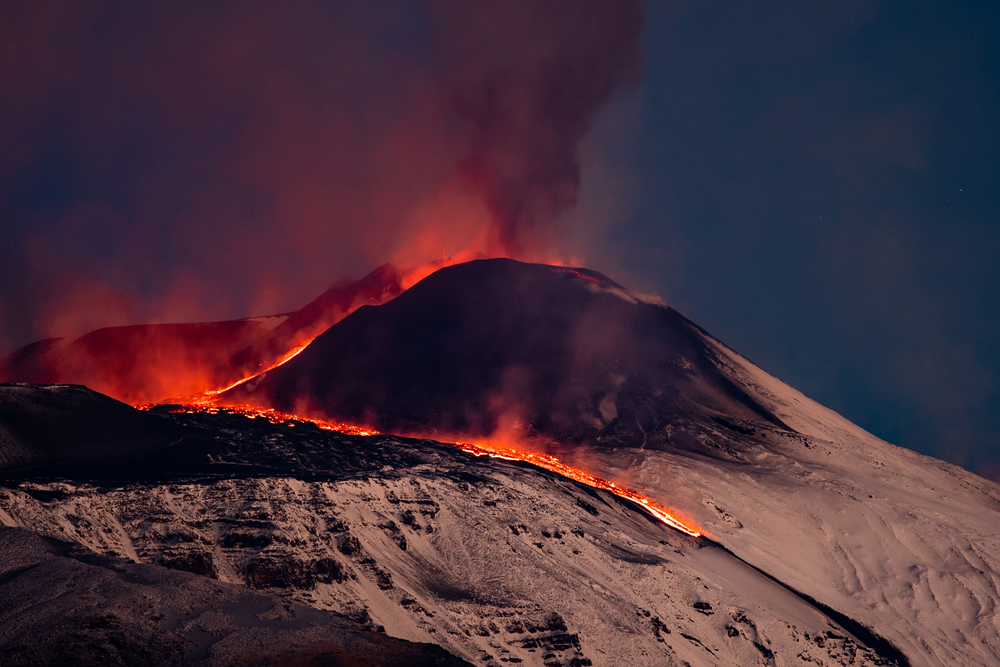 Mount Etna erupts in Sicily. Volcano erupt lava into the air and lava flow.