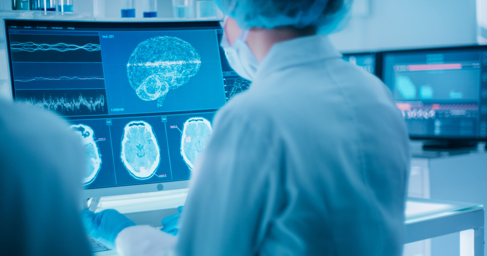 Scientists studying brainwave scanning models and DNA sequencesl.