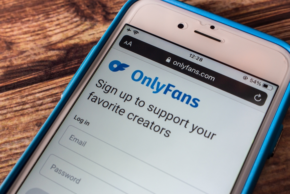 Kumamoto, JAPAN - Jun 27 2022 : Logo of OnlyFans, a subscription social platform for content creator and fan, in its website on an iPhone on shabby chic table. It is based in London, UK.